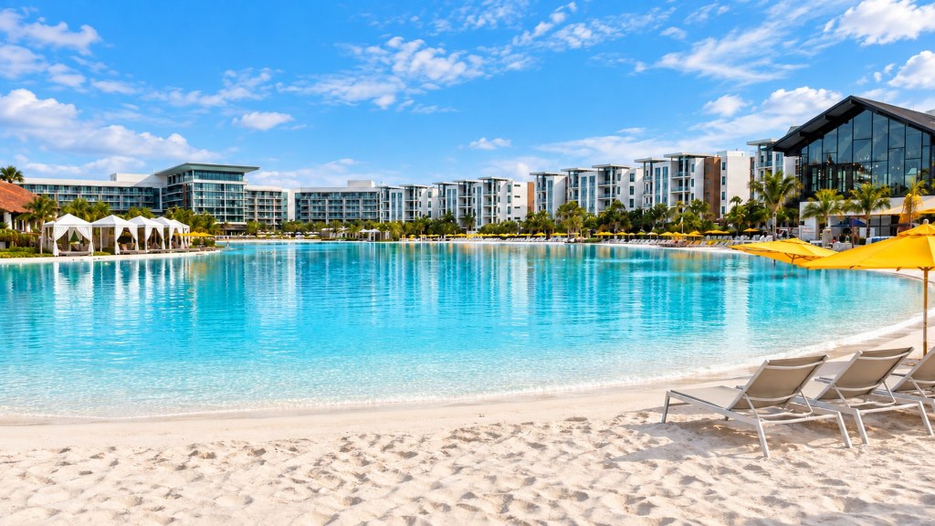 Evermore Bay at Evermore Orlando Resort, with turquoise water, a white sand beach, lounge chairs, and yellow umbrellas.